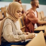 young woman wearing hijab while taking notes durin 2022 12 06 01 01 38 utc