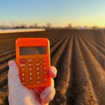 calculator in the hand of a farmer on the backgrou 2022 11 09 06 40 49 utc