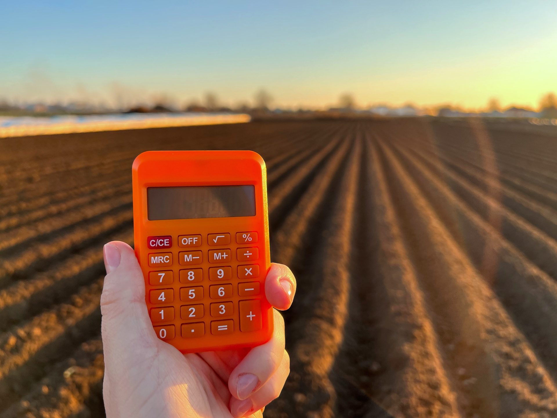 calculator in the hand of a farmer on the backgrou 2022 11 09 06 40 49 utc