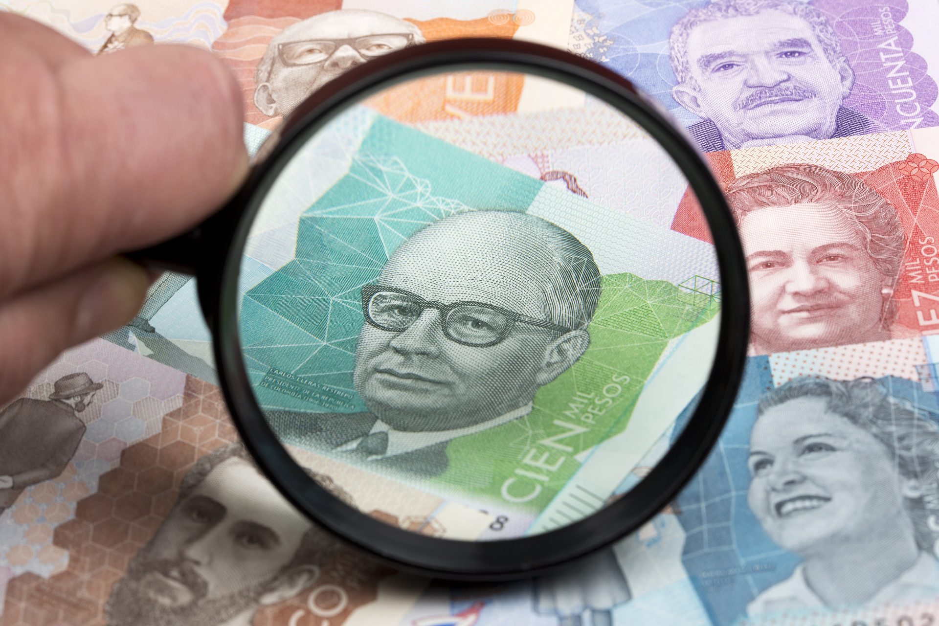 colombian peso in a magnifying glass 2021 08 29 13 39 28 utc