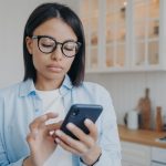 concentrated woman texting and consulting online o 2022 07 14 15 53 52 utc