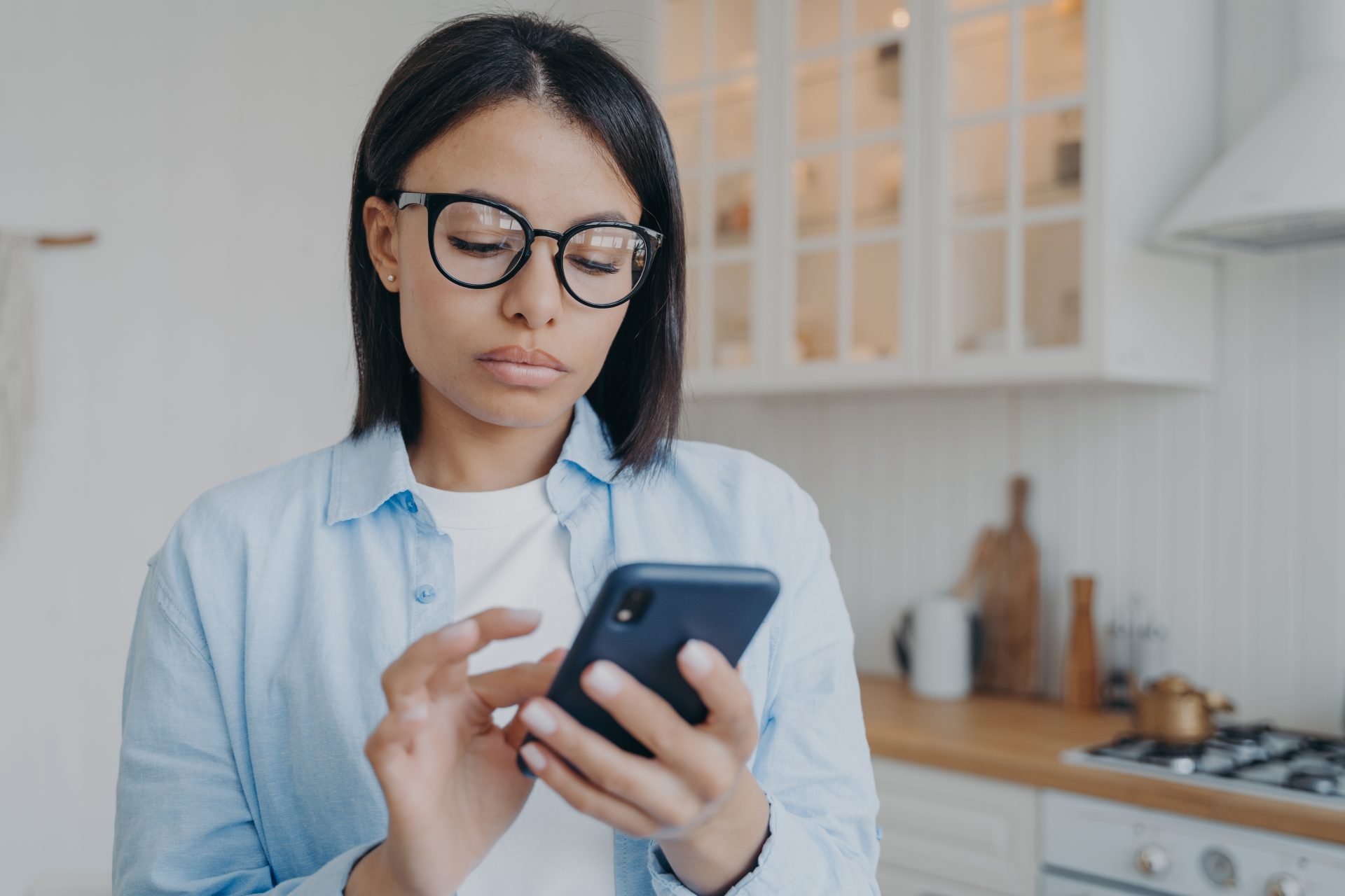 concentrated woman texting and consulting online o 2022 07 14 15 53 52 utc