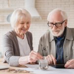 grandparents putting coin into moneybox economy f 2022 02 04 00 38 05 utc