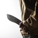 man holding a machete behind his back 2021 09 03 01 32 00 utc