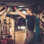 professional car mechanic changing motor oil in a 2021 08 26 16 21 11 utc