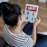 rear view of young woman watching sales on the tab 2021 08 27 22 39 26 utc