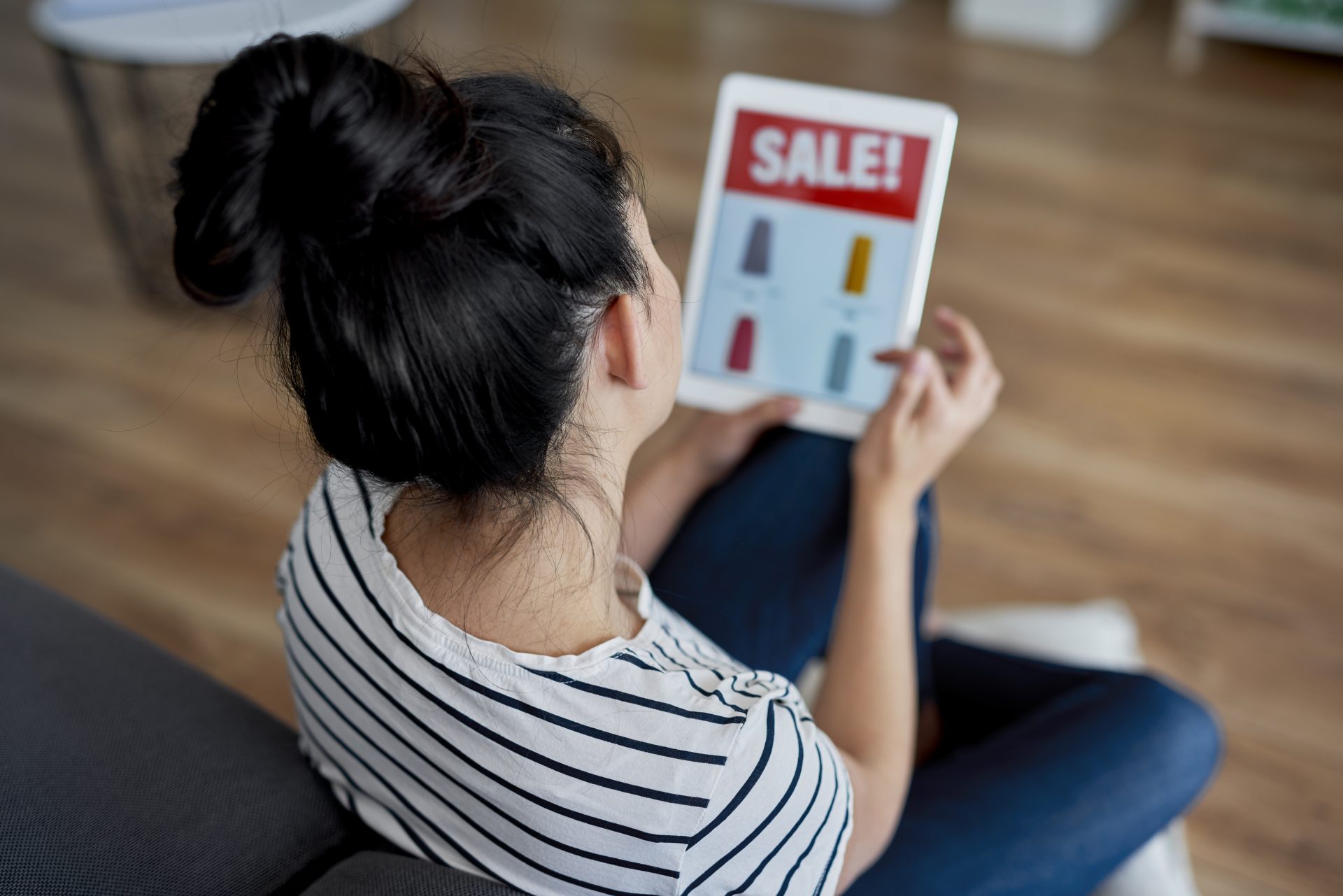 rear view of young woman watching sales on the tab 2021 08 27 22 39 26 utc