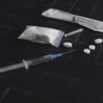 syringe and pills on dark background close up 2022 06 09 14 29 14 utc