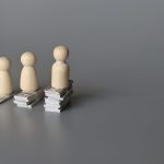 wooden dolls and stack of money with copy space fo 2023 05 19 20 20 18 utc