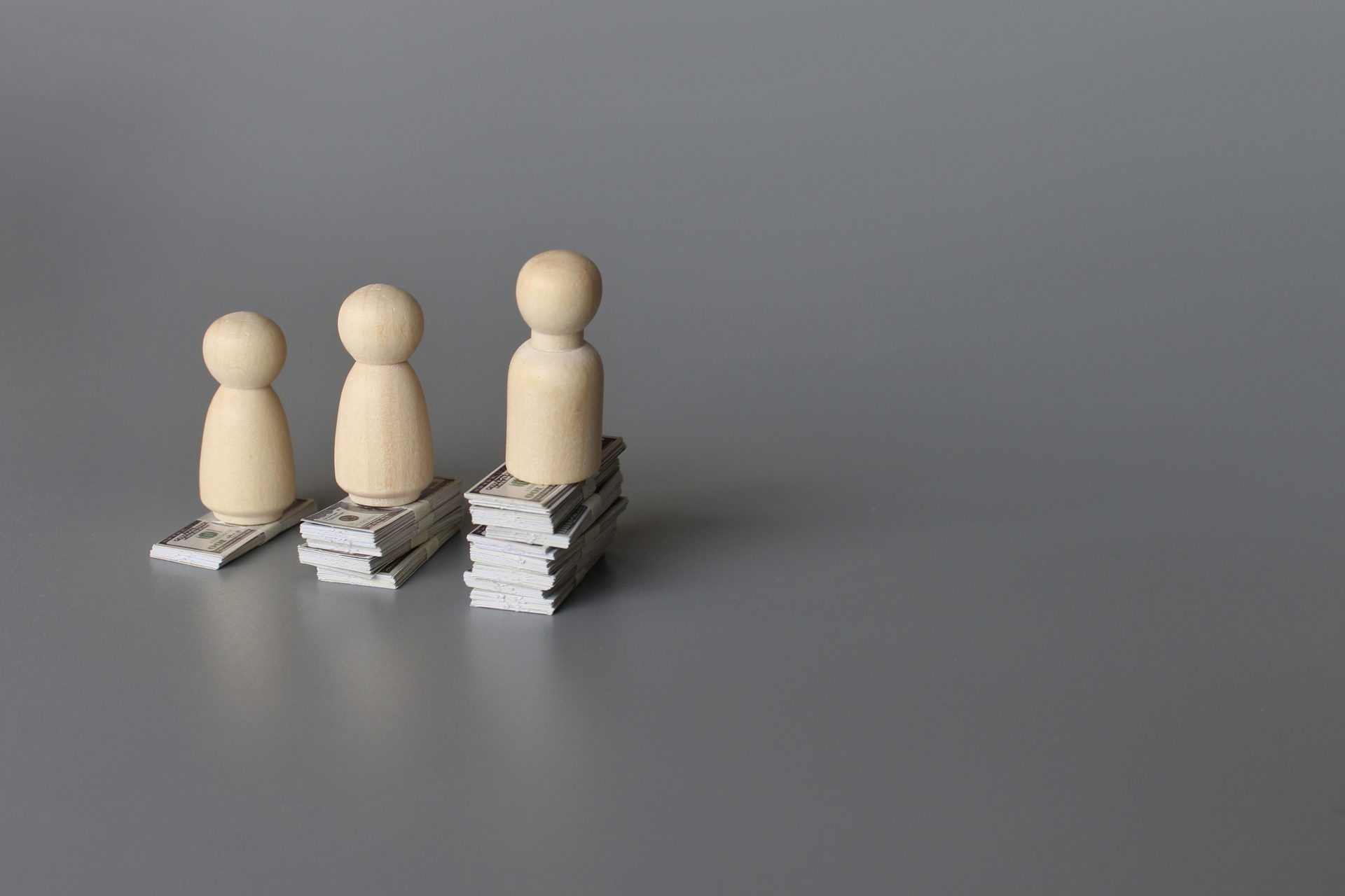 wooden dolls and stack of money with copy space fo 2023 05 19 20 20 18 utc