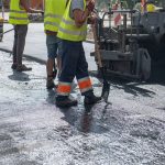 workers operating asphalt paver machine during roa 2022 12 03 02 57 07 utc