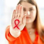 young woman showing hiv red loop drawn on hand 2021 12 14 18 47 29 utc