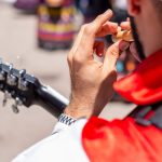 close up of a man playing a bamboo flute outdoors 2022 08 18 19 21 24 utc