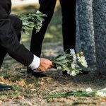 cropped view of senior man putting flowers near to 2022 12 16 20 42 42 utc
