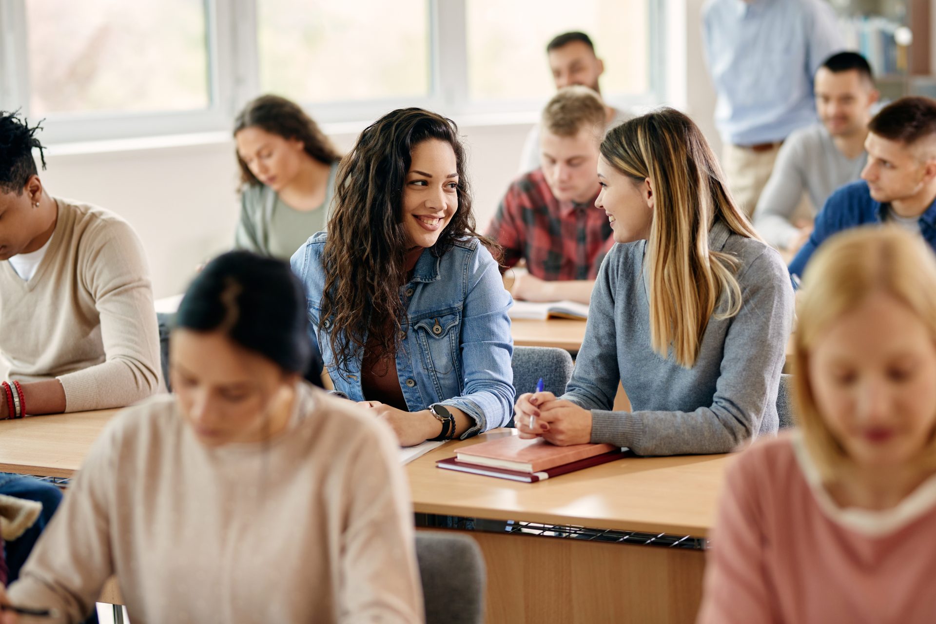 happy female students talking during a class at un 2023 02 02 18 54 47 utc