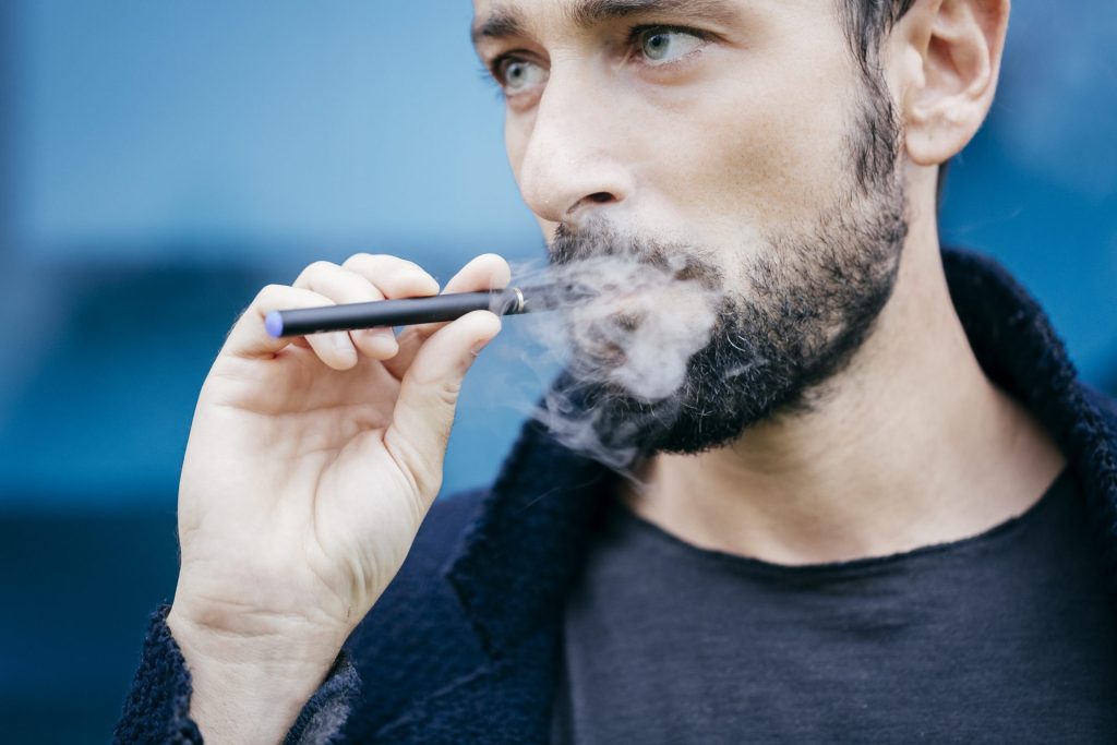 portrait of man smoking an electronic cigarette 2022 03 04 01 45 18 utc