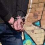 rear view of the arrested and handcuffed offender 2022 11 14 16 03 13 utc