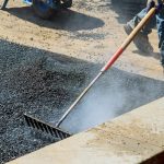 workers on asphalting paver during road street rep 2022 11 12 10 36 06 utc