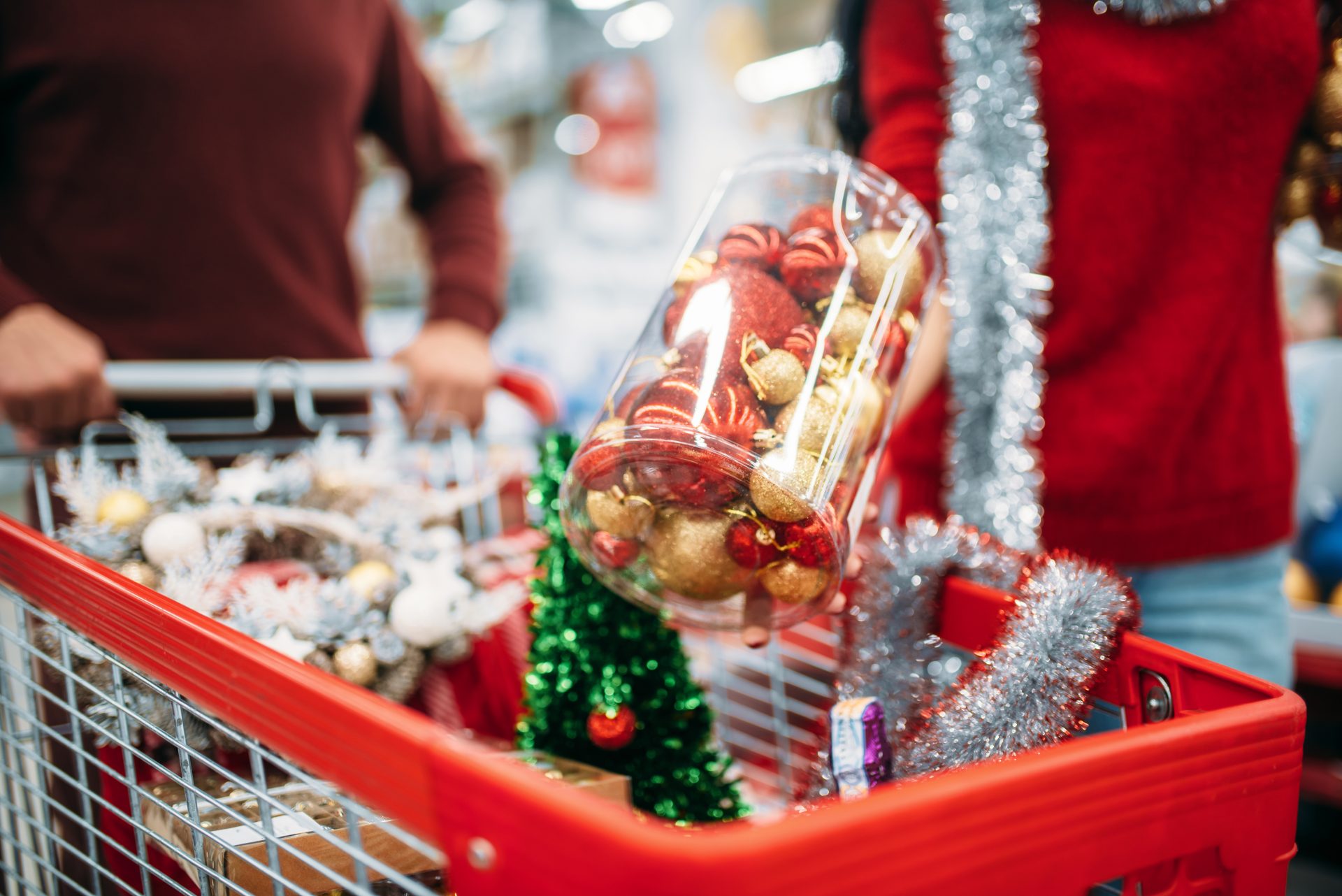 young couple put in a cart christmas decorations 2021 08 26 16 26 41 utc