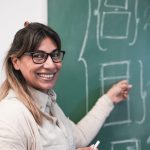 mature latin female teacher smiling on camera insi 2023 11 27 05 27 00 utc