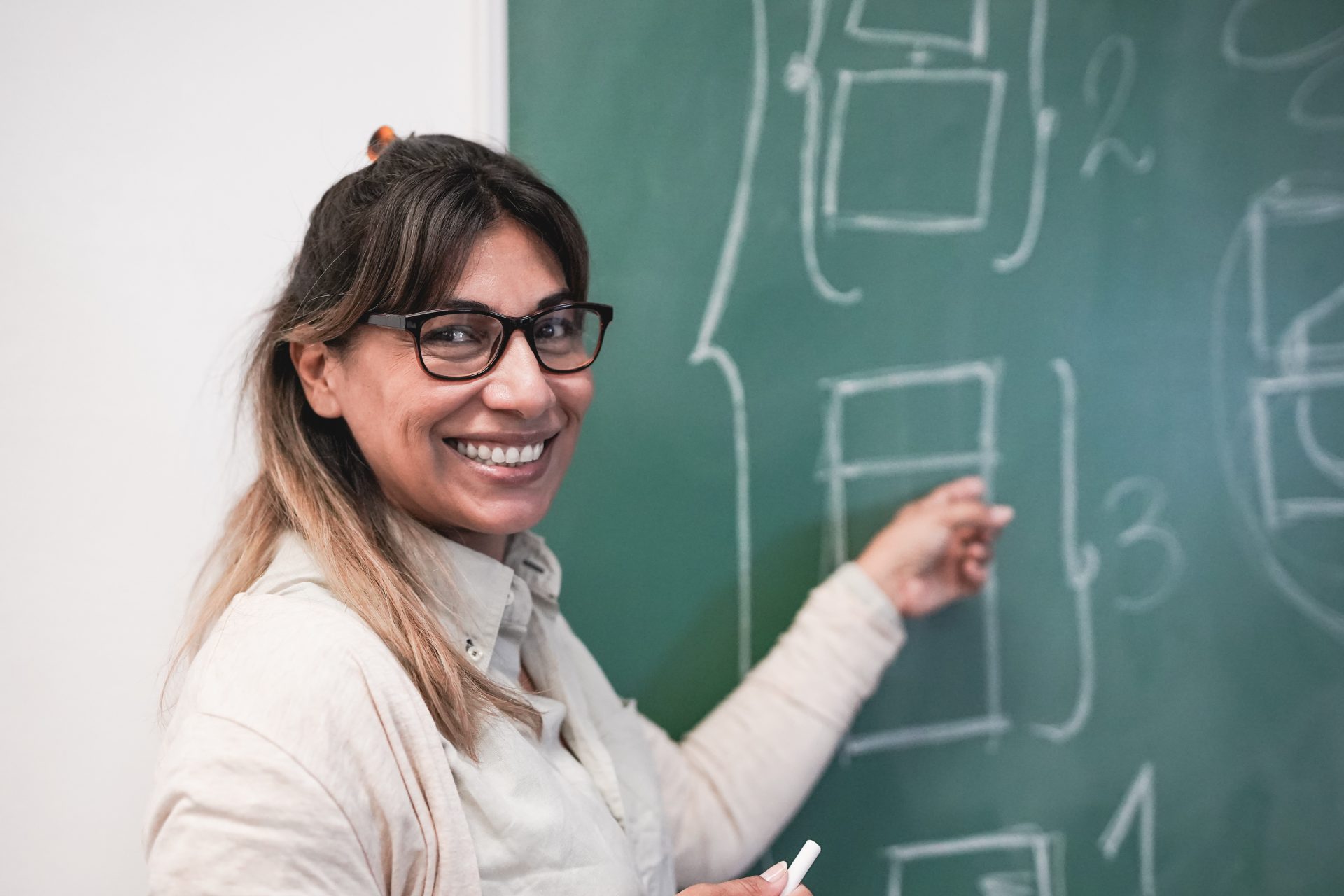mature latin female teacher smiling on camera insi 2023 11 27 05 27 00 utc