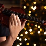 teen playing violin in formal wear on christmas ba 2023 11 27 04 49 19 utc