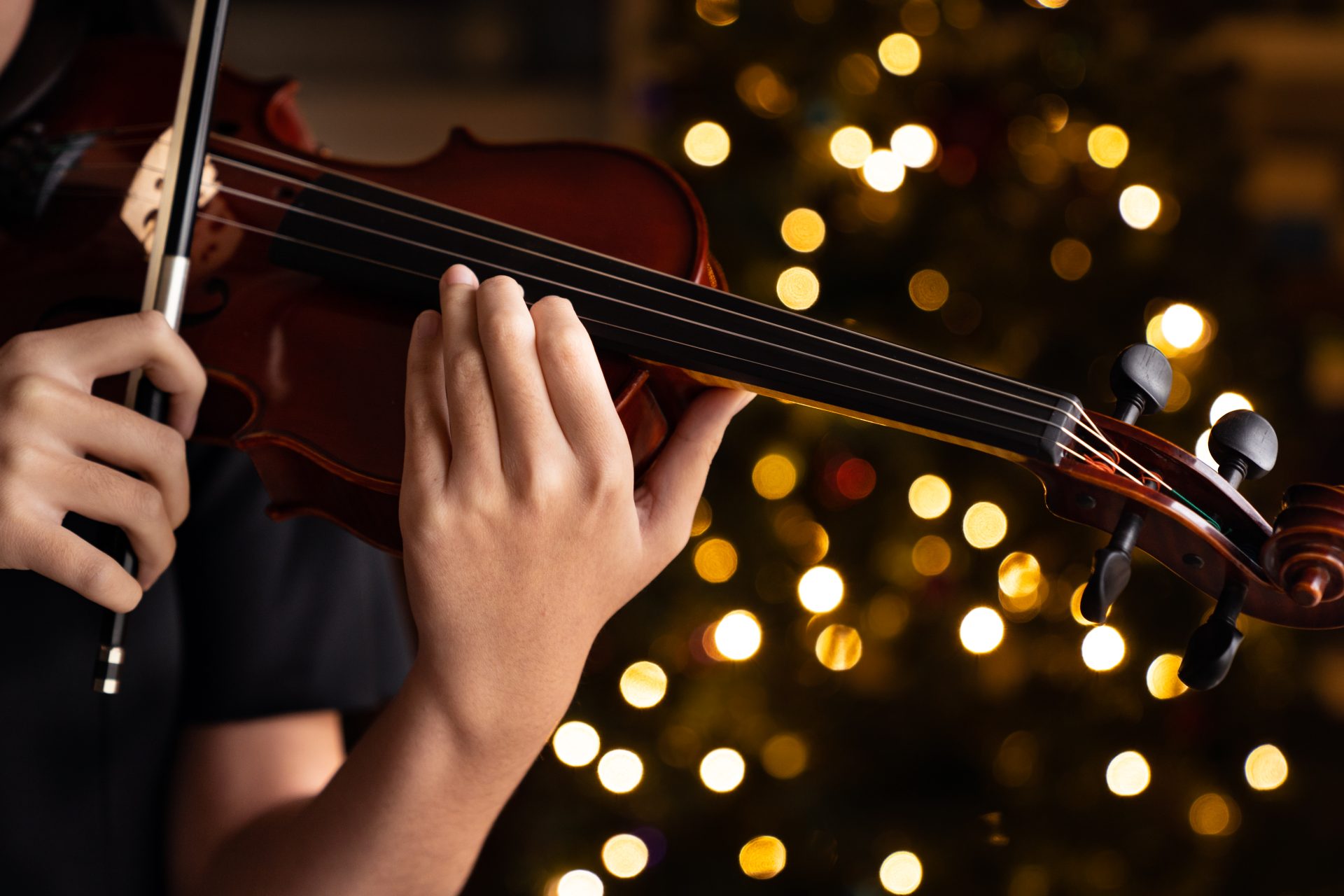 teen playing violin in formal wear on christmas ba 2023 11 27 04 49 19 utc