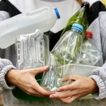 woman holding armful of various used plastic items 2023 11 27 05 02 28 utc