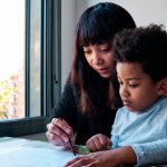 young latin mother coloring with her son at home 2023 11 27 05 32 51 utc