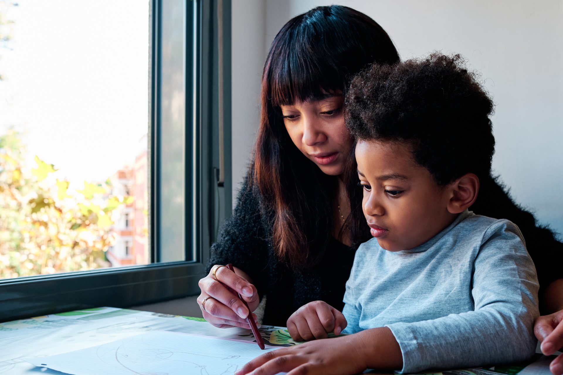 young latin mother coloring with her son at home 2023 11 27 05 32 51 utc