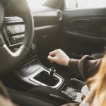 a person holding a manual shift knob in the vehicl 2023 11 27 05 17 28 utc