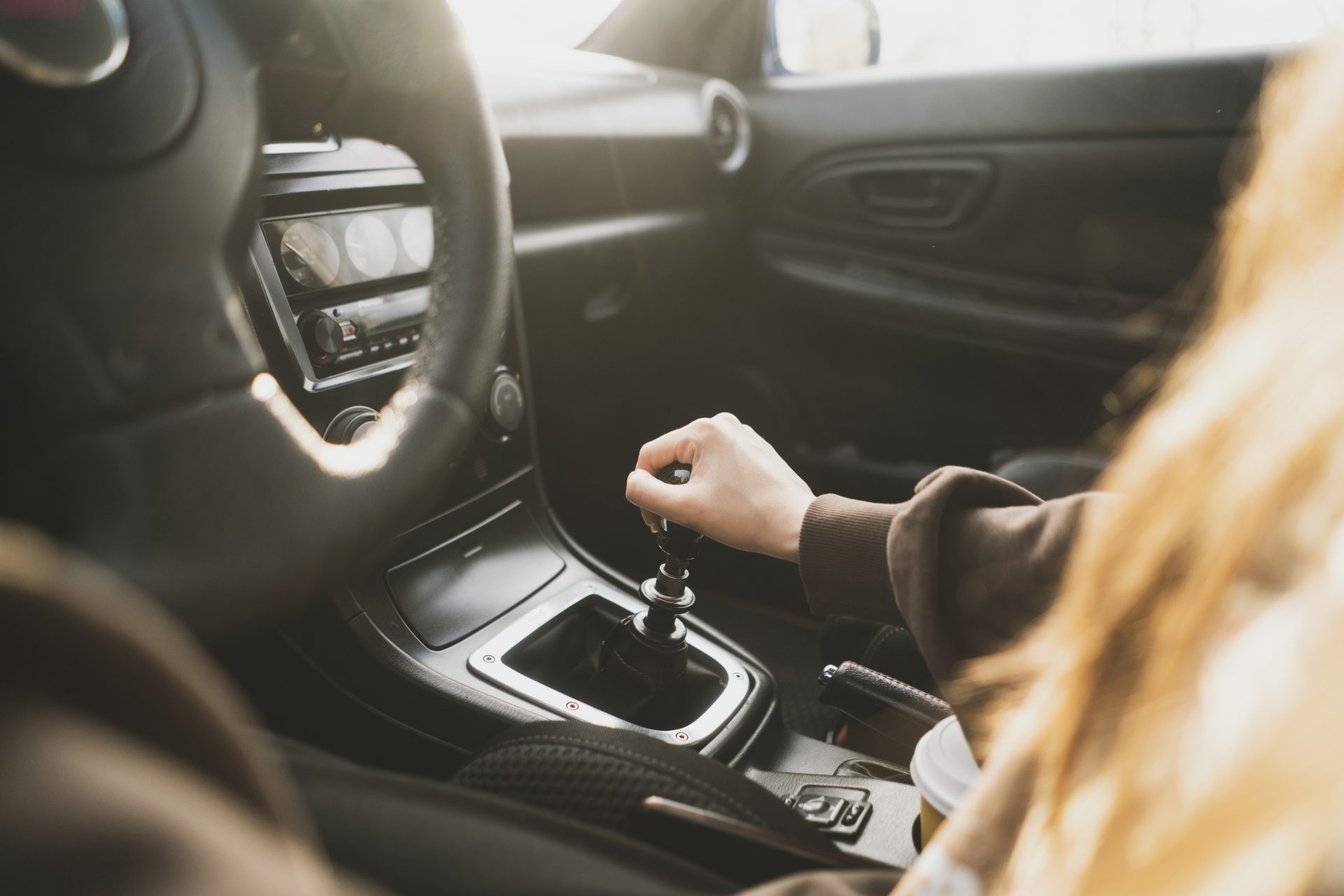 a person holding a manual shift knob in the vehicl 2023 11 27 05 17 28 utc