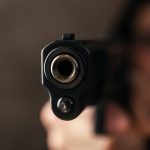 man hold pistol selective focus robber violence 2023 11 27 05 17 00 utc