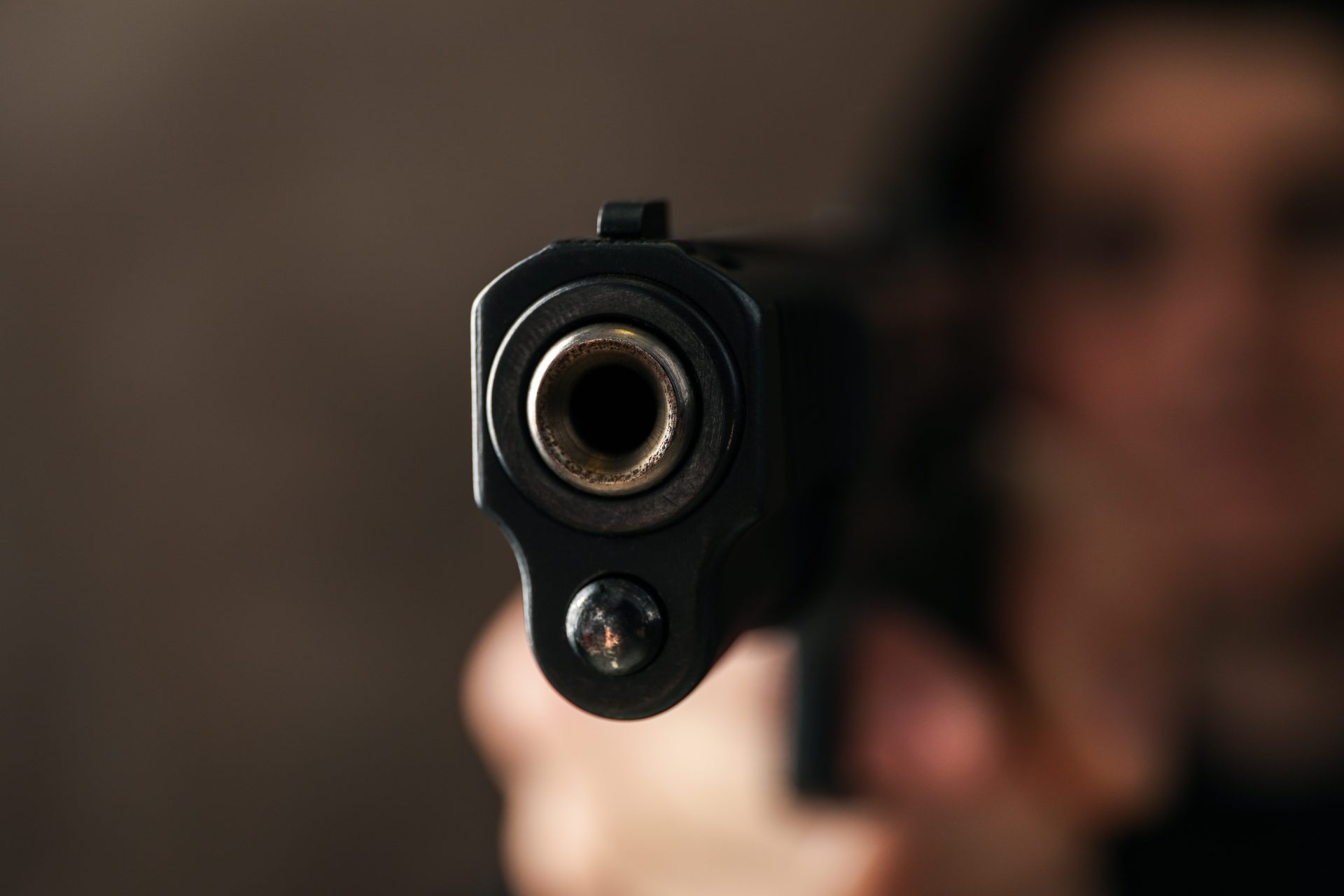 man hold pistol selective focus robber violence 2023 11 27 05 17 00 utc