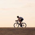 muscular athlete in helmet cycling on asphalt road 2023 11 27 05 35 21 utc