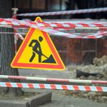 warning roadworks sign and safety barrier on city 2023 11 27 04 50 34 utc