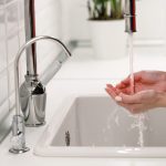 woman washing and cleaning her hands under flowing 2023 11 27 05 10 48 utc