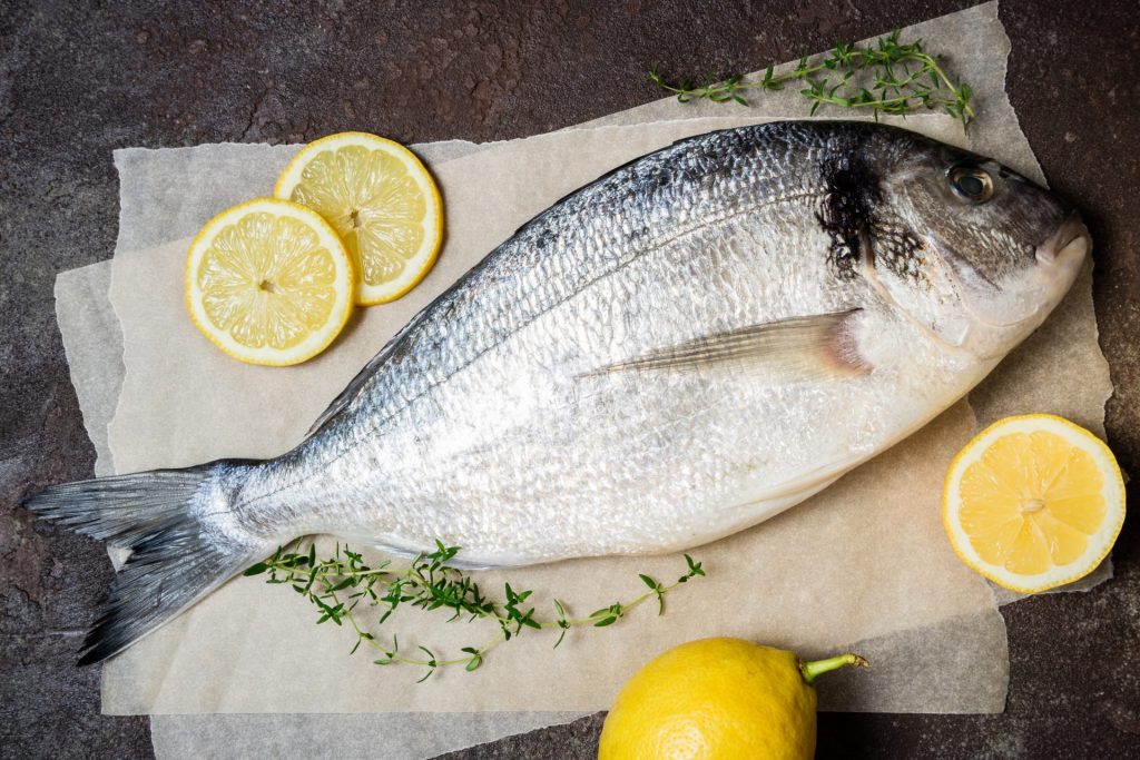 fresh raw fish closeup dorado fish with lemon and 2023 11 27 04 50 54 utc