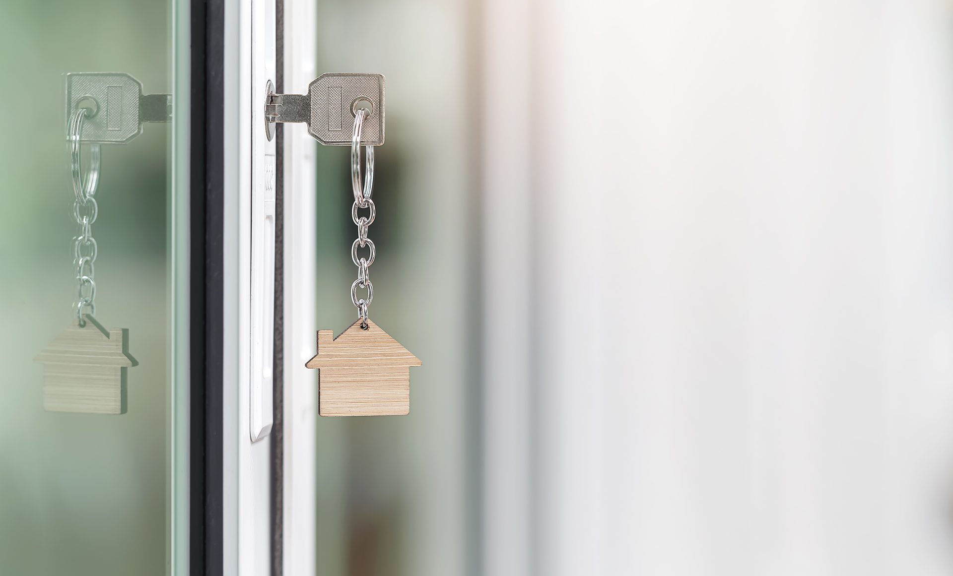 key with house shape keychain in the door keyhole 2023 11 27 05