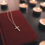 religious cross on bible with candles 2023 11 27 05 06 17 utc
