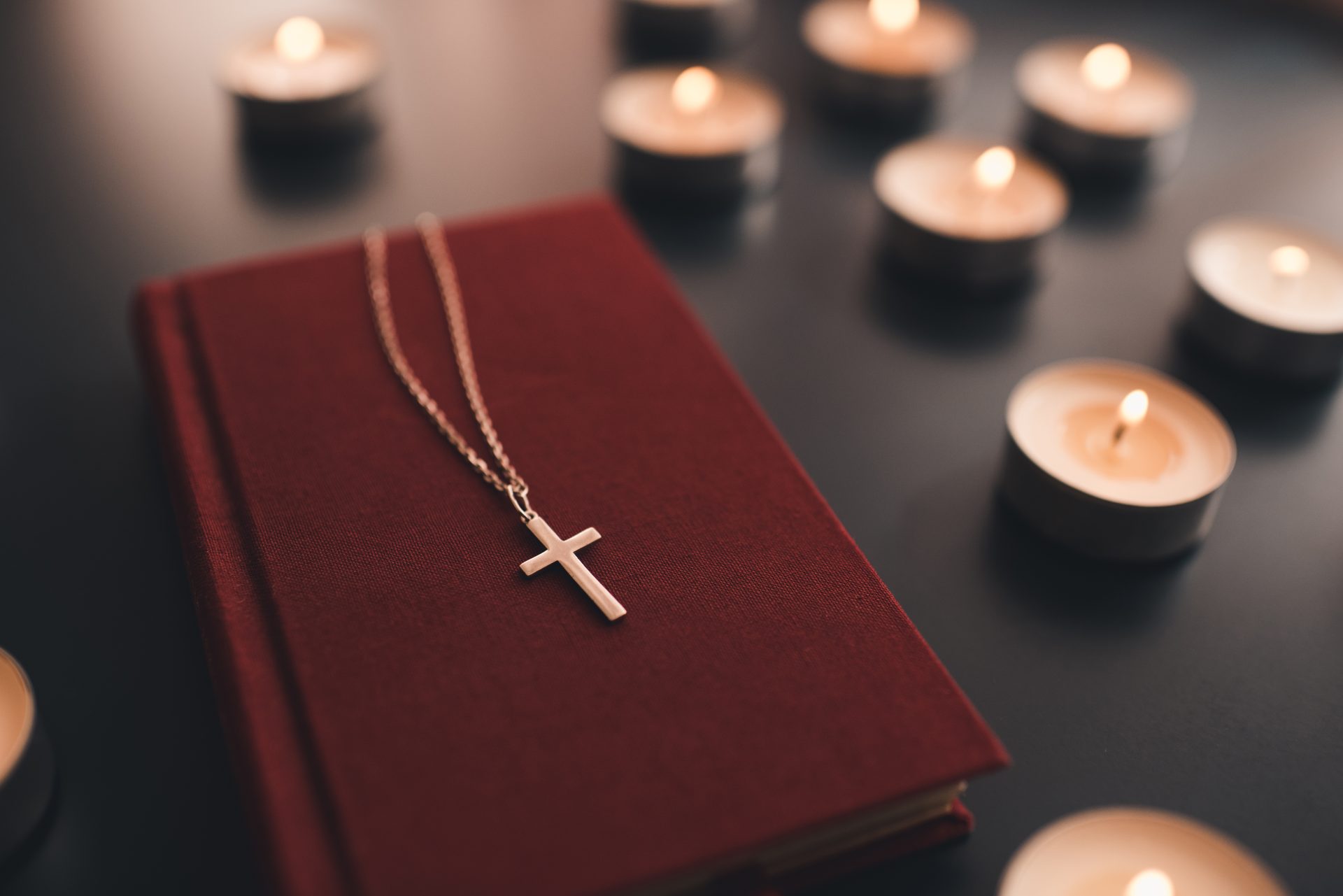 religious cross on bible with candles 2023 11 27 05 06 17 utc