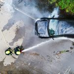 two firefighters extinguishing a burning car after 2023 11 27 05 22 23 utc