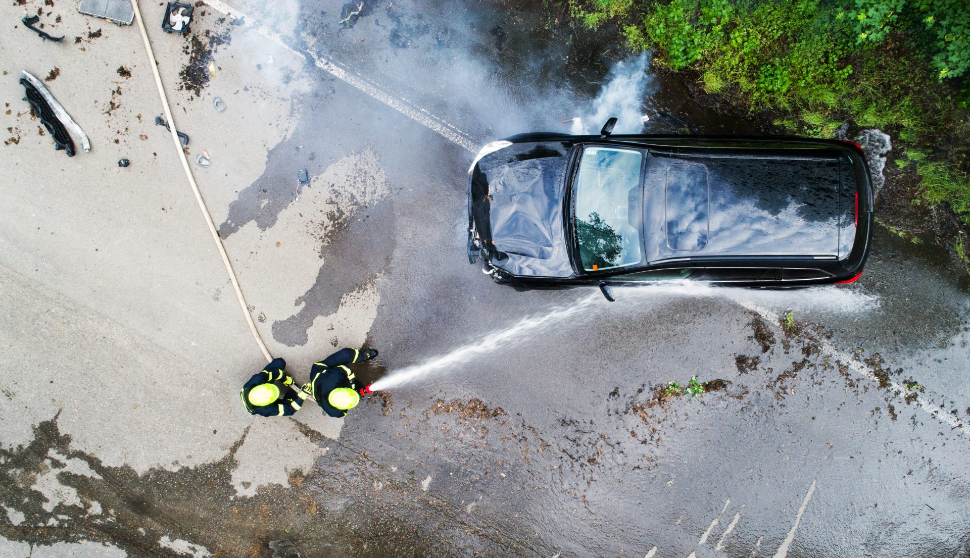 two firefighters extinguishing a burning car after 2023 11 27 05 22 23 utc