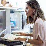 woman working on computer at reception desk 2023 11 27 05 09 12 utc
