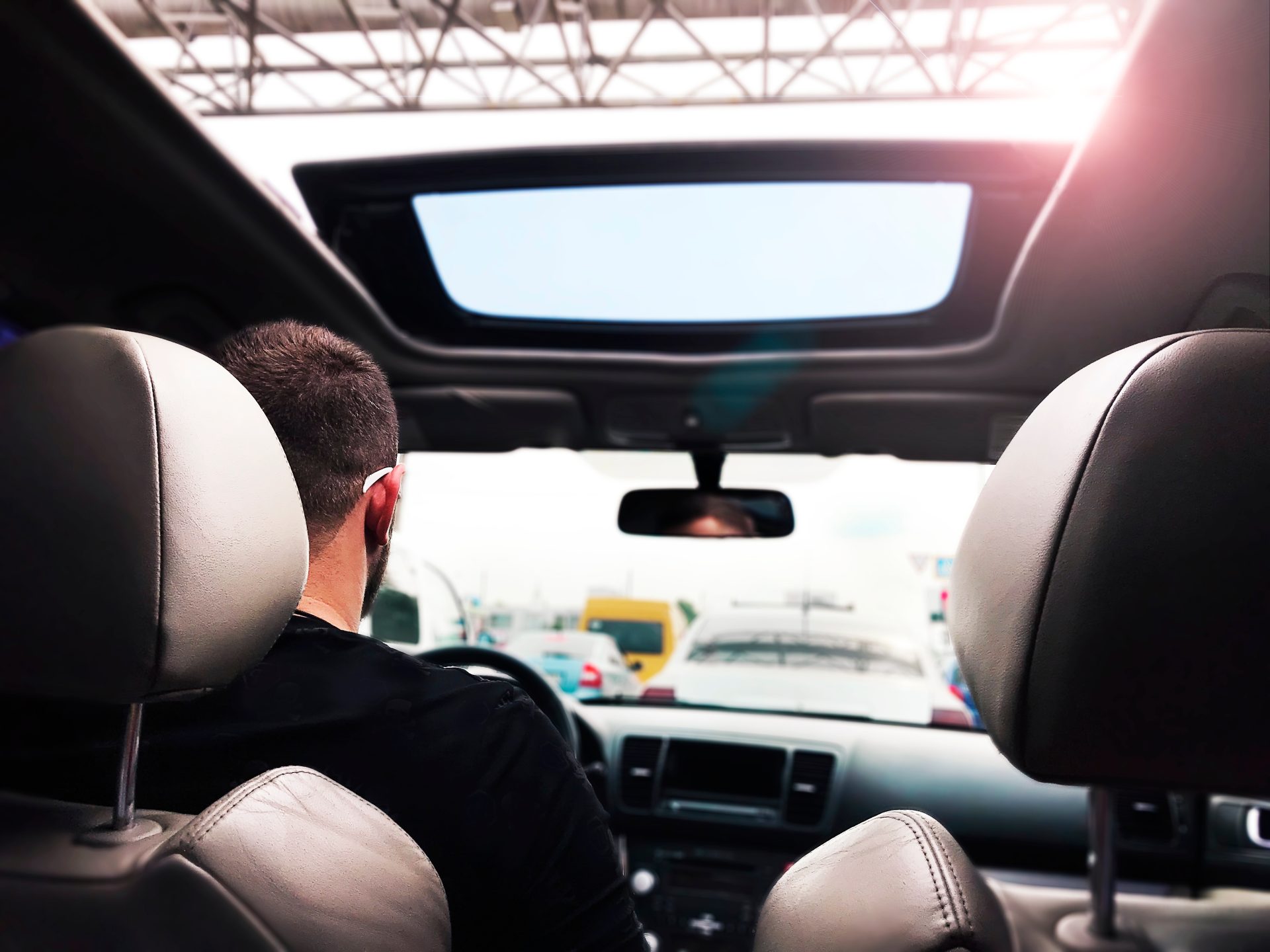 young man driving a car with a glass roof by the c 2023 11 27 04 53 02 utc