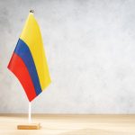 colombia table flag on white textured wall 2023 11 27 05 29 13 utc
