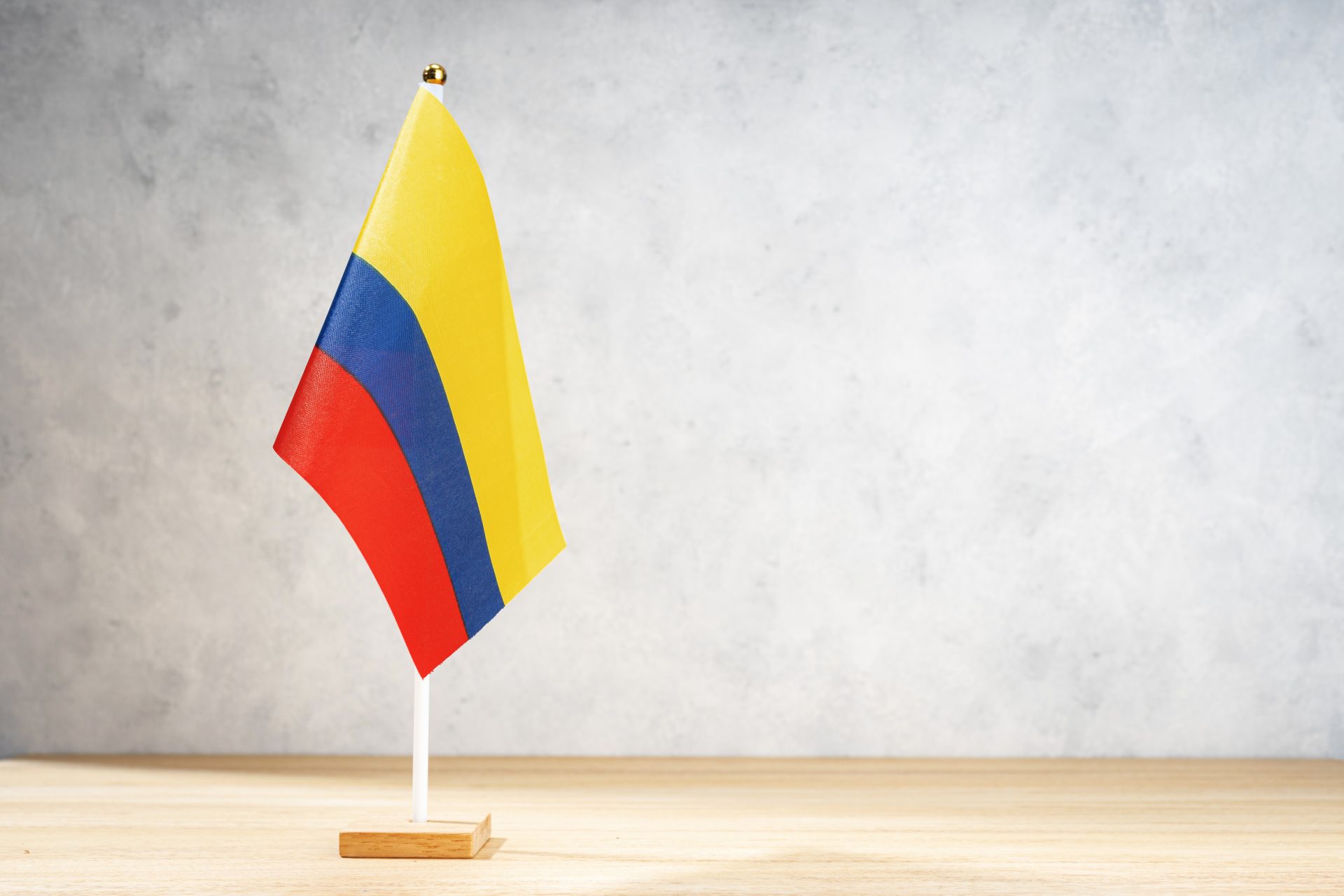 colombia table flag on white textured wall 2023 11 27 05 29 13 utc