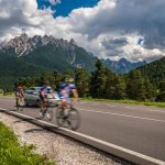 cyclists riding a bicycle on the road in the backg 2023 11 27 05 00 24 utc