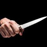 male hand holding knife on black background 2023 11 27 05 20 06 utc