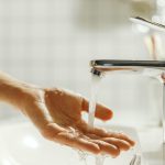 man washing and cleaning her hand in bathroom fing 2023 11 27 05 09 57 utc
